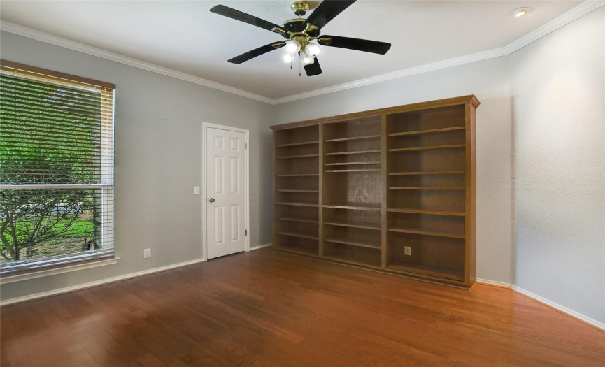 The ideally situated office, off of the entry has wood flooring, built-in shelving, and a spacious closet making for an ideal study and work space.