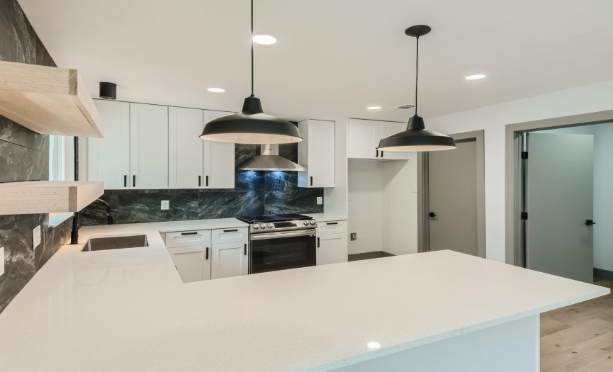 Your new stunning kitchen with beautiful quartz counter tops, kitchen being convenient to the garage (closed door) and wait until you see your massive pantry!