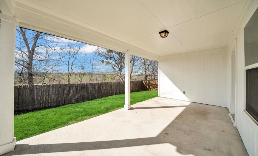 Private backyard with green space behind at 401 Purple Martin
