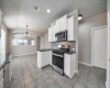 Stainless steel appliances and granite  countertops in kitchen at 401 Purple Martin