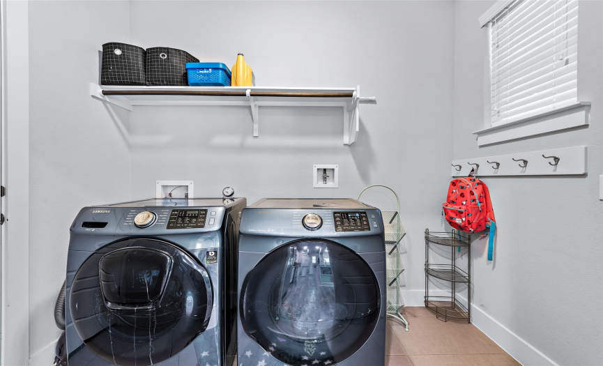 The laundry is light & bright with room for backpacks or coats on the built-in hooks