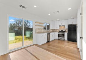 Remodeled kitchen with qaurtz countertops and stainless steel appliances. 