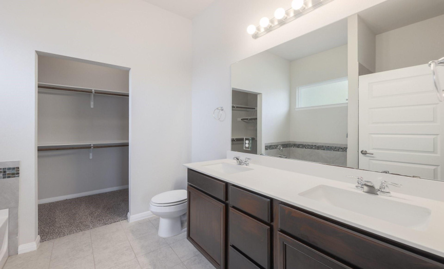 Primary bath with double vanity and double hang closet