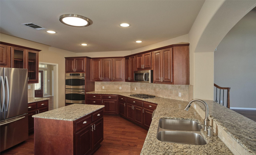 This kitchen is a chefs delight!  It boasts a gas cooktop, double ovens and a center island.