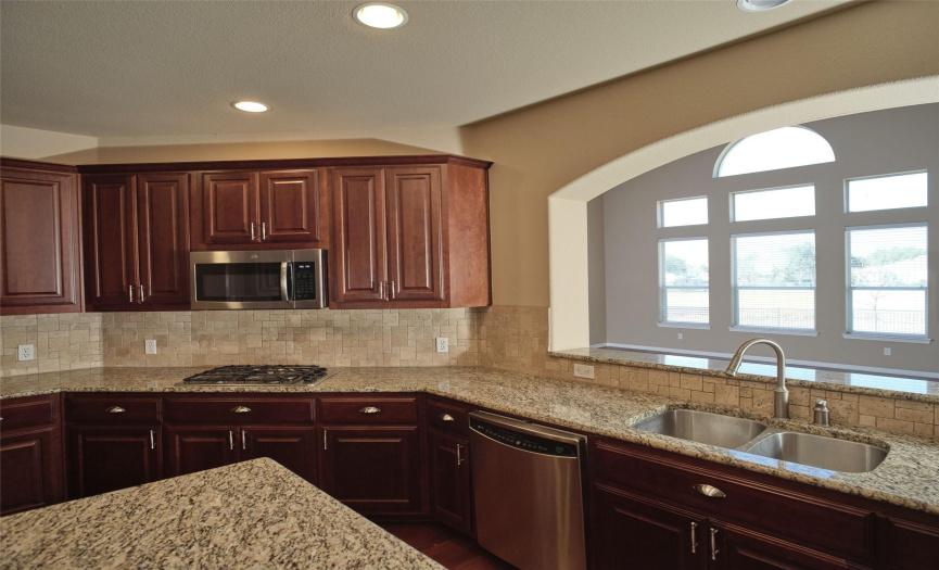 The kitchen is located in the center of the home overlooking the greatroom and open to the formal dining room and breakfast nook.