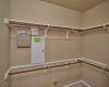 Owners suite closet has double hung rods for ample clothes storage.