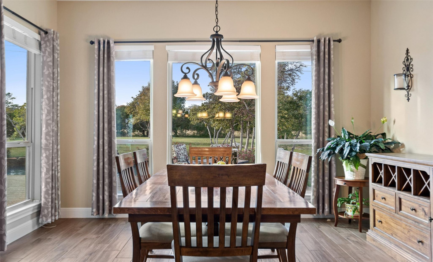 Large enough for large table and hutch, the dining area is just off the kitchen and surrounded by light.