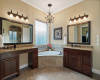 Two vanities with ample storage and great lighting. 