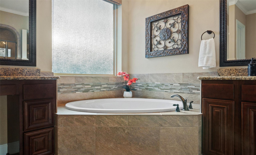 Soak away in large garden tub beneath a glamorous chandelier for your touch of luxury. 