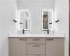 The en-suite bath features a quartz-topped double vanity with backlit mirrors.