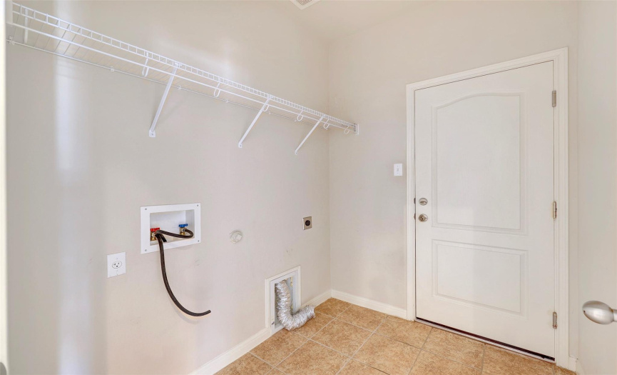 Laundry room with ample space for a full size washer and dryer. 