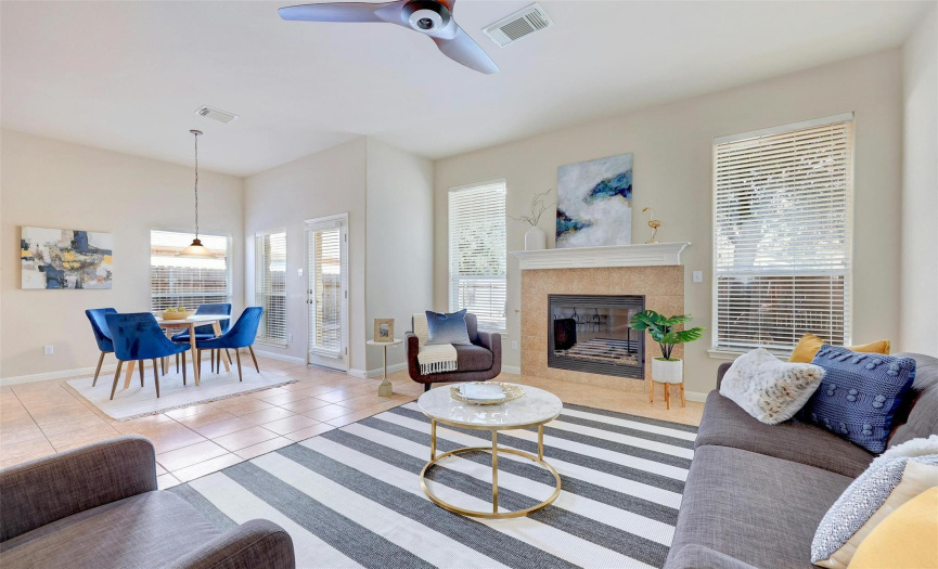 Bright welcoming living area with a fireplace leads to a breakfast nook. 