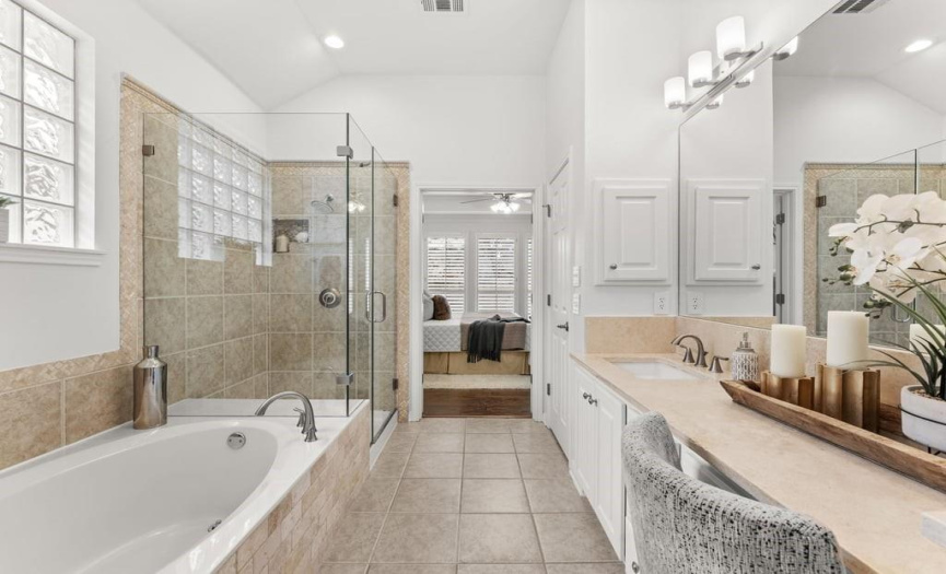 The primary bathroom has a large walk-in shower and garden tub.