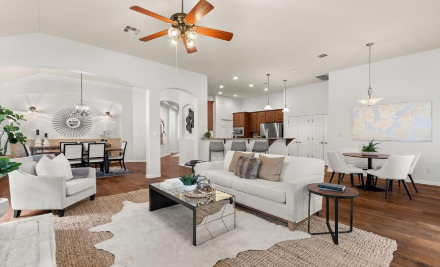 This open-concept living area has been freshly painted and features beautiful hardwood floors.