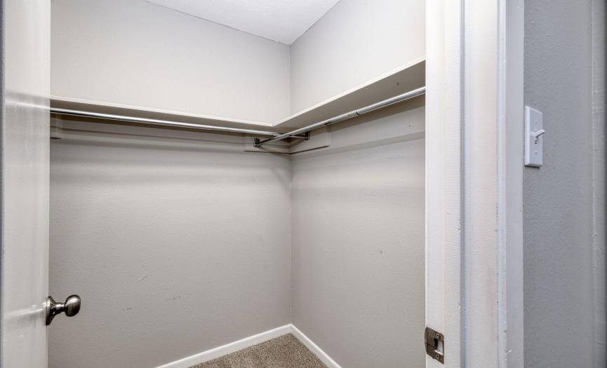The primary closet has plenty of room for storage.