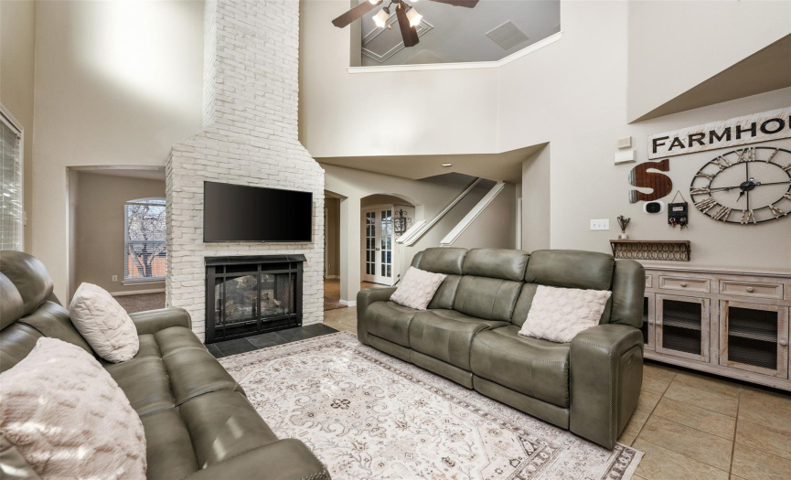 Gorgeous details and high ceilings in the family room with white brick fireplace