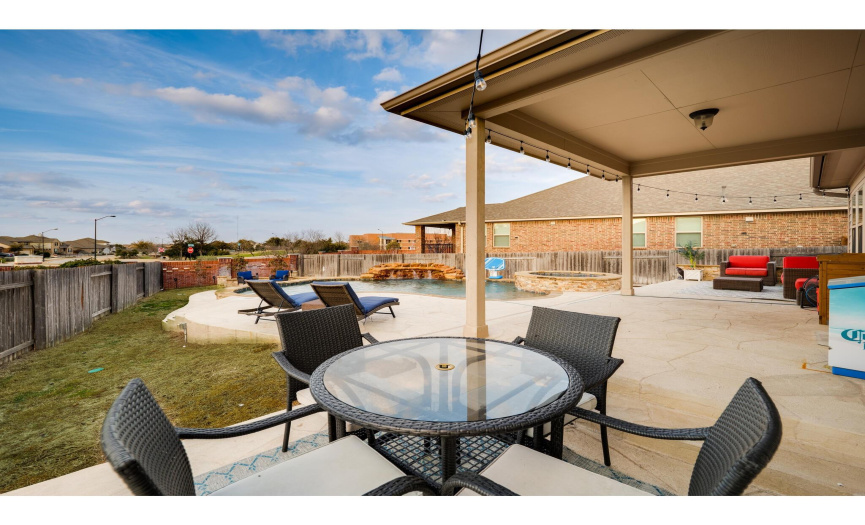 The sprawling patio is equipped with covered and uncovered spaces.