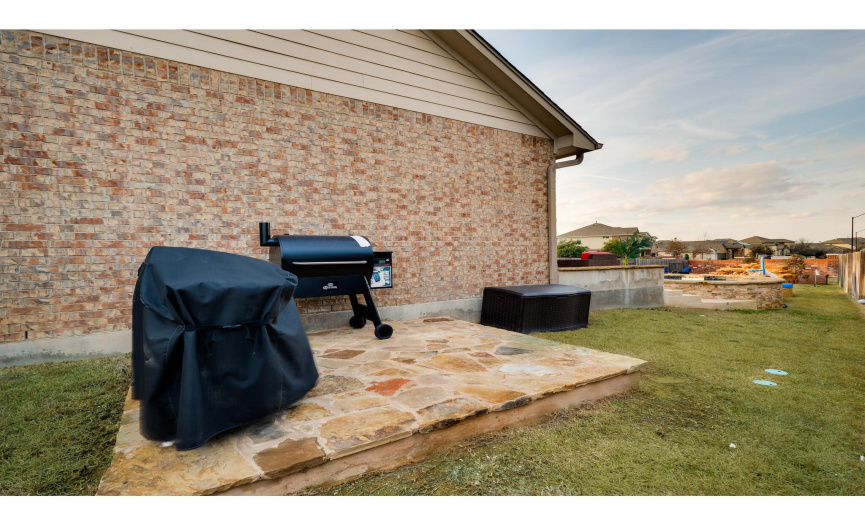 A separate pad on the side of the home is ideal for additional grilling/smoking.
