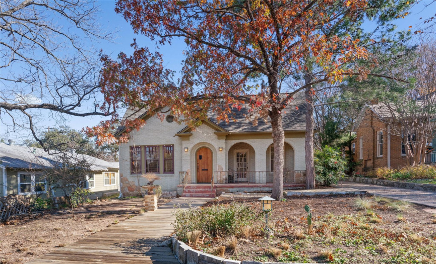 Historic 1930's brick charmer with beautiful exterior architectural features including; inlaid stonework in the brick, rounded archways, hand crafted wooden screens, metal porch railing & magnificent front door