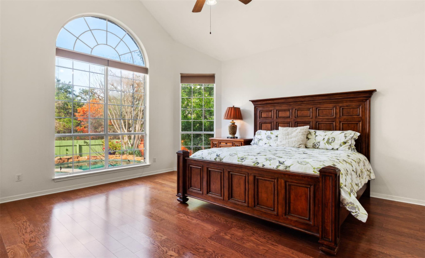 Gorgeous, large master bedroom with soaring ceilings and views over the pool and back yard. 