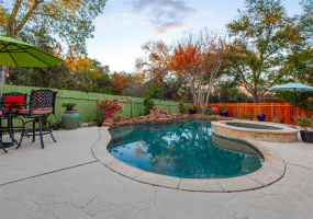 Gorgeous inground pool with hot tub backing to permanent greenbelt!  This back yard is amazing, with local flora and fauna, xeriscaping, multiple living areas and privacy.