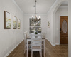 The front entry guides you to the first dining space, a formal dining room centered by a chandelier.