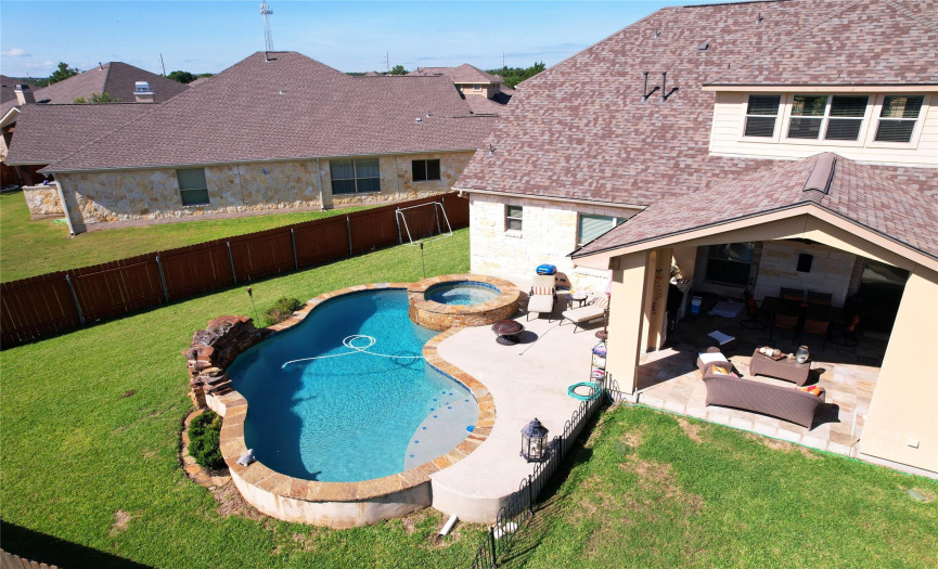 This home has a large swimming pool and an amazing covered Patio with summer kitchen