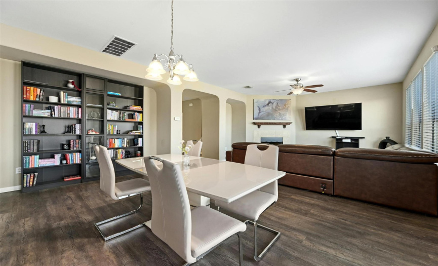 The centrally located dining area provides plenty of space for a sizable dining table and also showcases an arching nook with space for your dining hutch, buffet, bookcases, and more. 