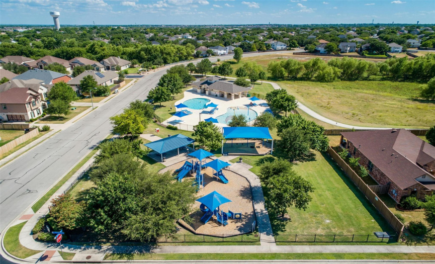 Residents of Spring Trails enjoy an amenity center with a pool splash pad, a fenced-in park with a playground, picnic pavilion, and walking trails. 