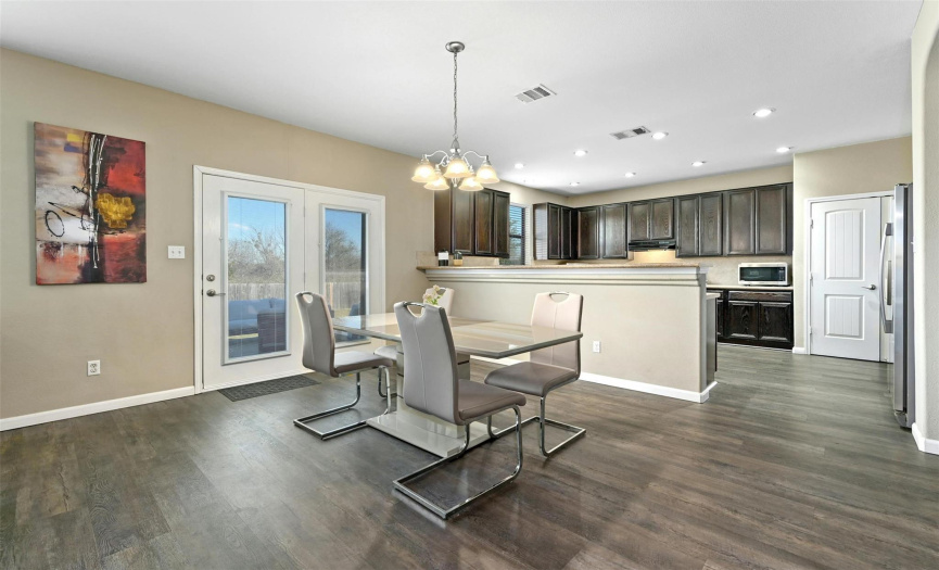 Easily entertain with this open concept floor plan. Featuring a centrally located dining area and tall bar seating along the kitchen peninsula. 
