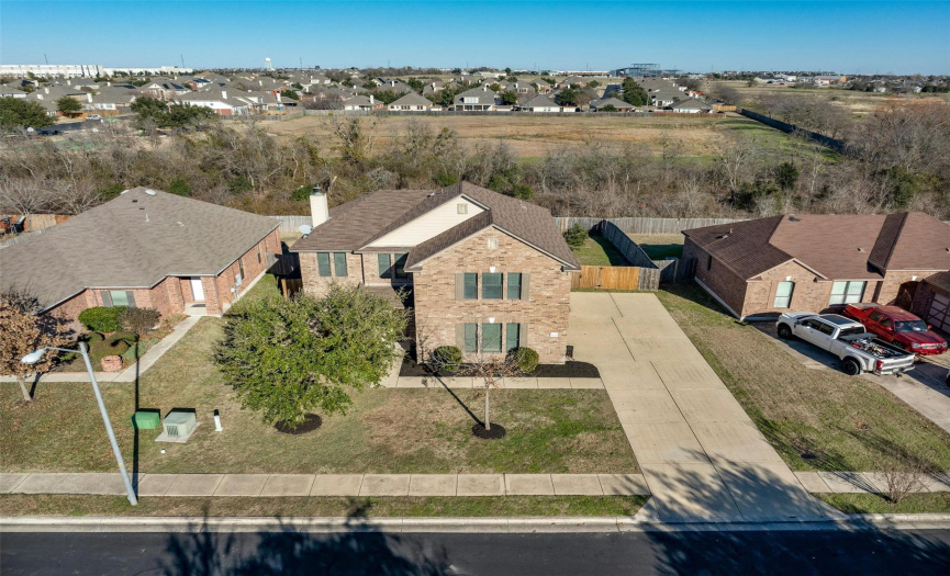 Nestled in Pflugerville’s Spring Trails community, this bright and spacious home offers a desirable location backing to a stretch of woods.