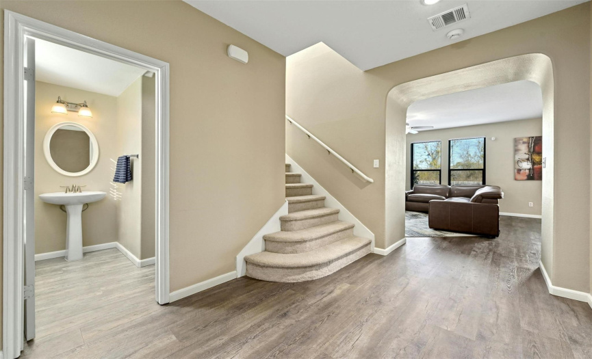 Step inside to discover a welcoming entry foyer with space for bench seating, credenzas, and more. Access the stairs and guest powder room from the foyer. 
