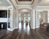 Greeted with Custom Woodwork on Ceilings and Wood Floors.