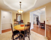 Notice lovely tray ceiling and chandelier in kitchen area open to dining room.
