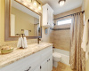 Guest bathroom has also been remodeled with gorgeous granite, beautiful tile flooring, framed mirror, new lighting fixture.
