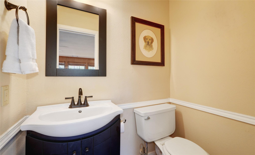 Half bath with sliding door off of the den perfect for guests.