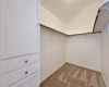 The large walk-in closet comes with built-in storage. 