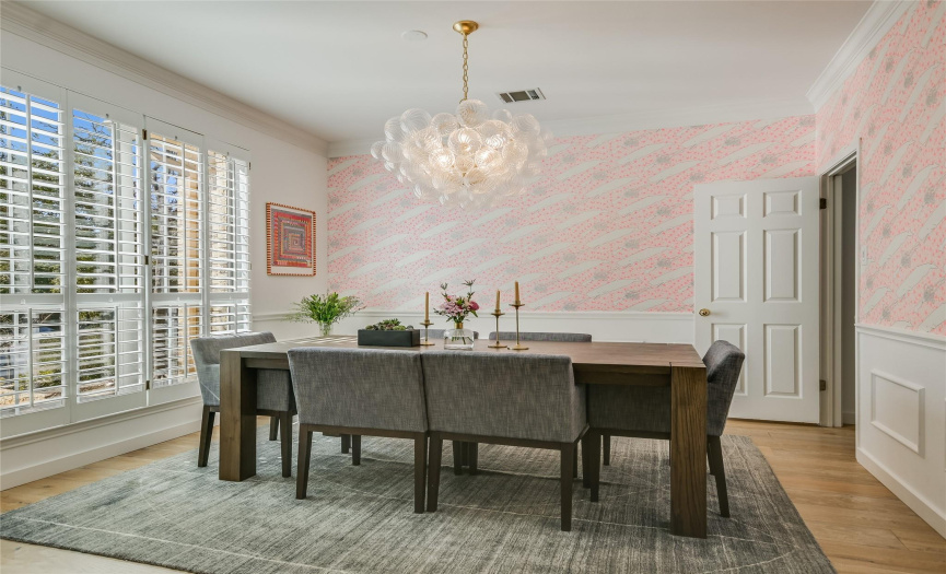 Bright and cheerful, designer wall paper in a whimsical pattern, Visual Comfort artisan glass chandelier.