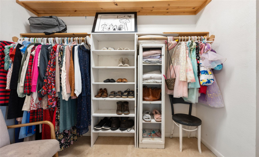 Walk in closet with built in shelves.