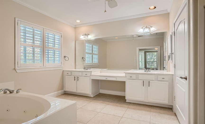 The large primary bathroom has double vanity and a jetted tub.
