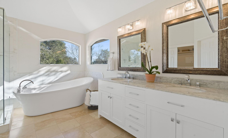  The stunning remodeled spa bath features a sleek vanity outfitted with marble counters.