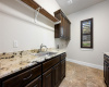 Laundry Room. Hanging bar, utility sink, granite countertops, ample counter & Cabinet space + room for a fridge.