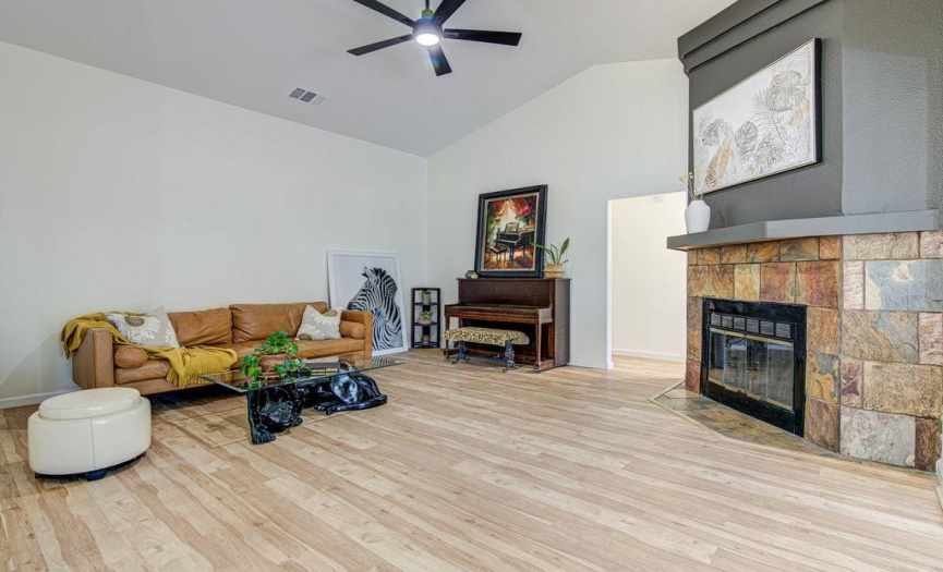 Living area features a wood fireplace with custom mantle, and recent ceiling fan with remote.