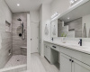 Recently remodeled primary bathroom, walk-in shower, no glass to clean, recent vanity with double integrated sinks, quartz countertop.