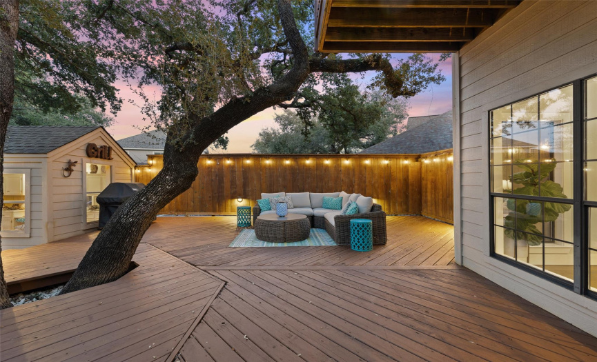 The majestic oaks add such a peaceful ambiance to the backyard seating area.