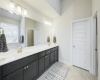 An elongated dual vanity offers abundance storage space.
