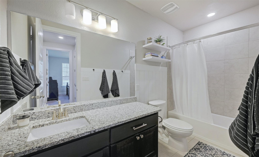 A well-appointed full bath is positioned ideally for the secondary bedrooms.