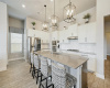 The kitchen showcases a large center island with three lovely pendant lights above.