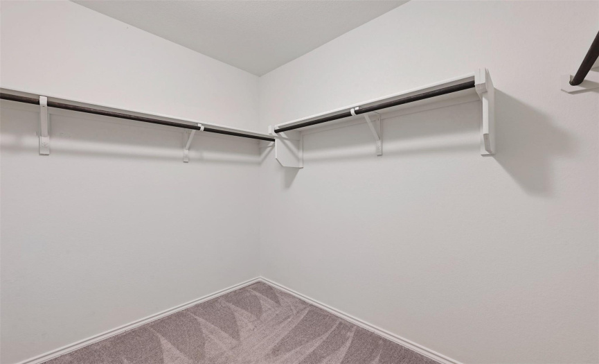 The primary walk-in closet provides ample storage space, keeping your wardrobe organized and easily accessible.