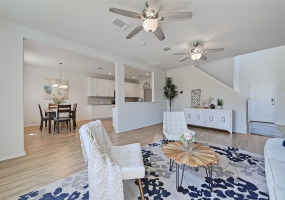 The living room seamlessly connects with the eat-in kitchen, creating an open-concept space that fosters connection and convenience for both daily living and entertaining.